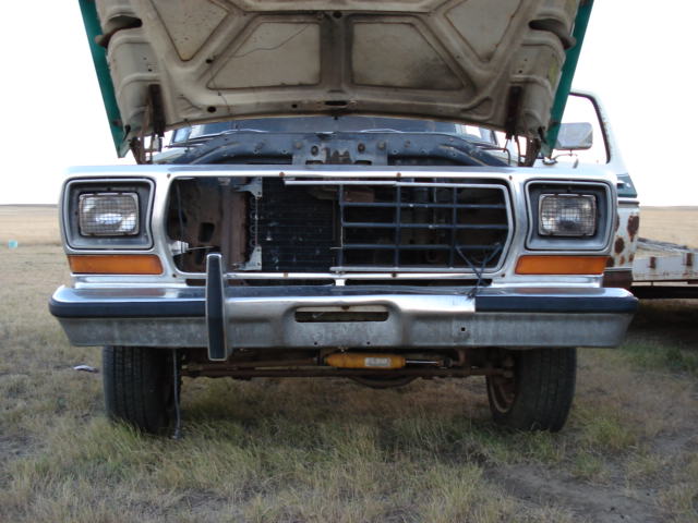 Front of a 1979 Ford Bronco with hood open, grille visible