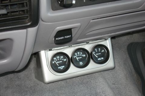 1994 Ford Bronco - Interior view of a vehicle's dashboard, showing water, oil, and voltage gauges.