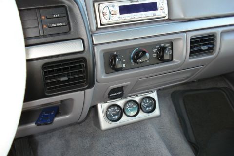 1994 Ford Bronco - Interior view of a 1994 Ford Bronco dashboard with aftermarket gauges installed.