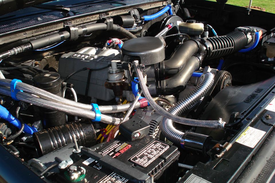 Engine bay with chrome hoses and blue accents