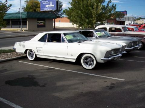 1972 Ford Ranchero - A white coupe with whitewall tires is parked in a lot next to other vintage vehicles.