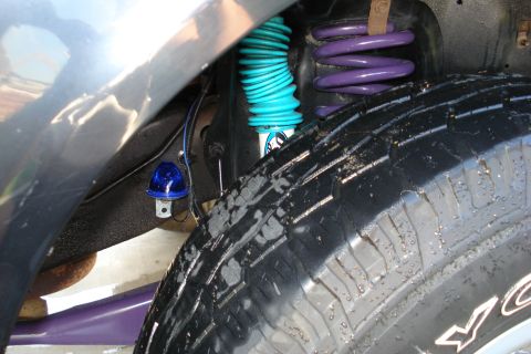 1994 Ford Bronco - Vehicle suspension components including a shock absorber, coil spring, and a blue warning light are visible.