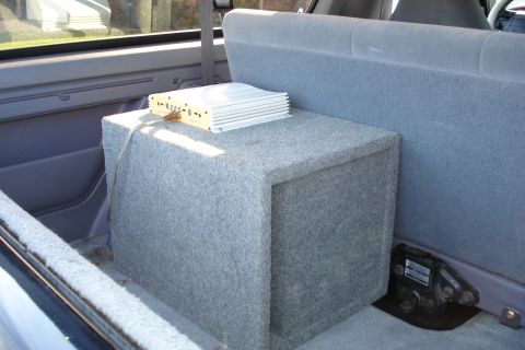 1994 Ford Bronco - A subwoofer box and amplifier are installed in the rear interior of a vehicle.
