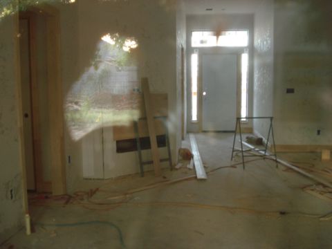 1994 Ford Bronco - House under construction shows unfinished interior with a doorway and windows, plus construction equipment.