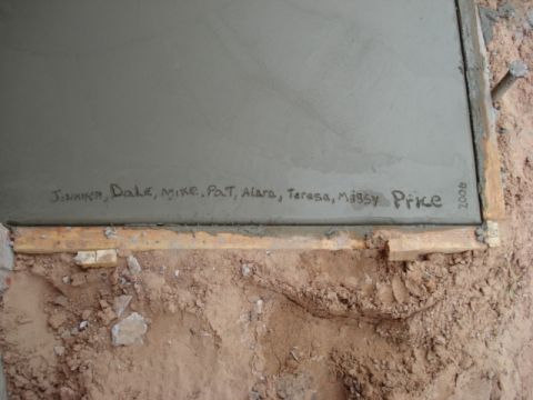 1994 Ford Bronco - Names and the year 2008 are inscribed into wet concrete, framed by wooden boards.