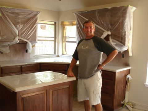 1994 Ford Bronco - A man poses in a kitchen where renovations are underway, with cabinets and countertops covered for protection.