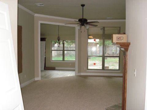 1994 Ford Bronco - This image shows the interior of a house, likely under construction or renovation, with large windows offering a view of the backyard.