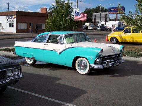 1972 Ford Ranchero - A classic turquoise and white 1955 Ford Fairlane Crown Victoria is displayed at an outdoor car show.