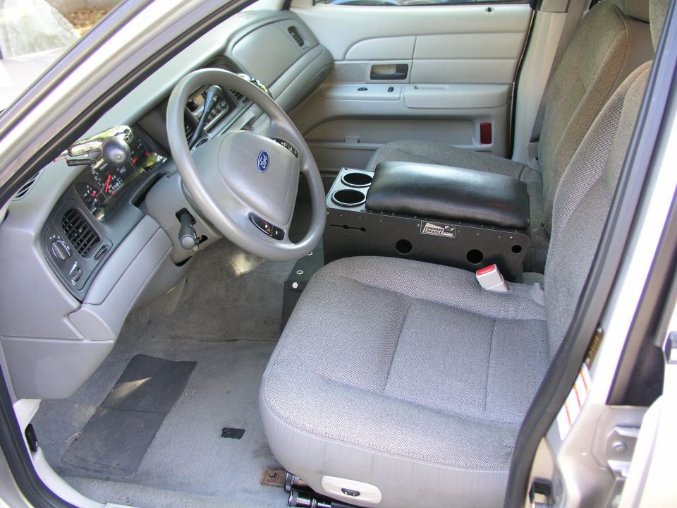 Gray cloth interior of Ford Crown Victoria with black aftermarket center console and column shifter