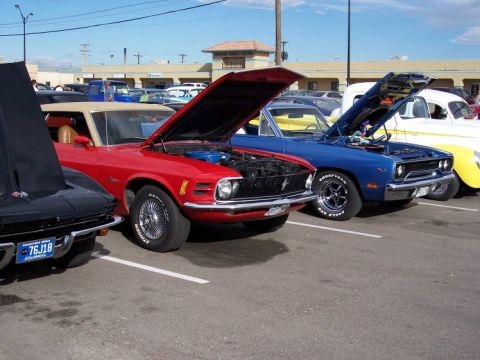1972 Ford Ranchero - Several classic cars are displayed with hoods open at an outdoor car show.