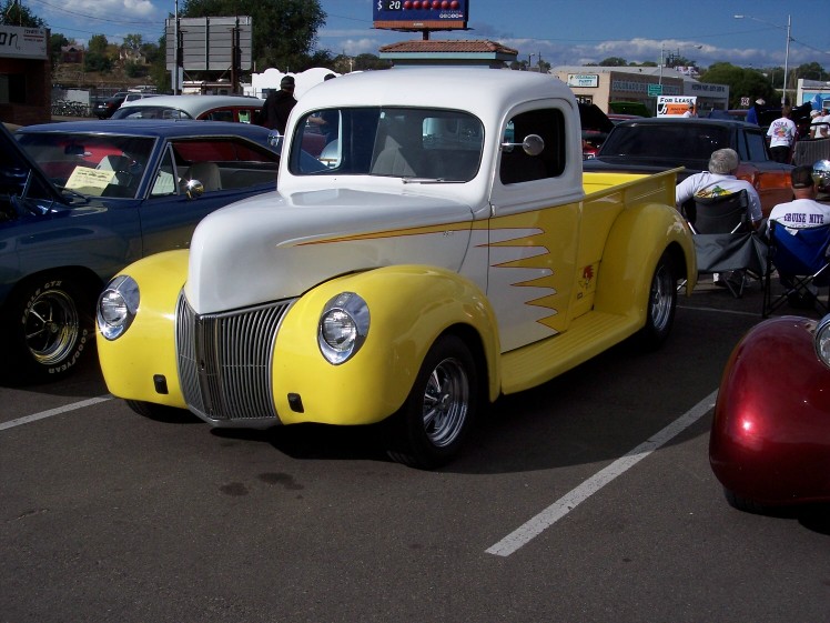 Yellow and white 1940s pickup truck with flame decals, 3q-front view