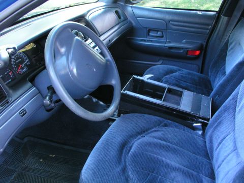 1999 Ford Crown Victoria - The interior of a 1998 Ford Crown Victoria, with blue fabric seats and a visible dashboard.