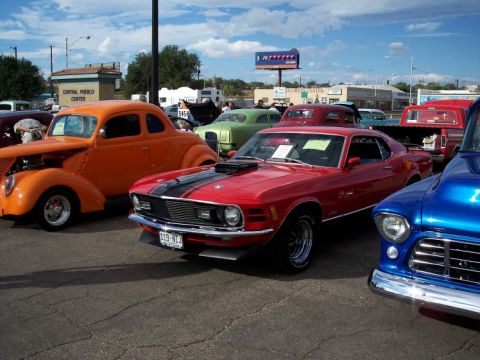 1972 Ford Ranchero - A red 1970 Ford Mustang Mach 1 is parked at a car show next to other classic vehicles.