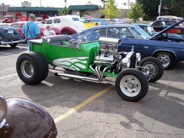 1972 Ford Ranchero - A custom green hot rod with a powerful engine is displayed at an outdoor car show.