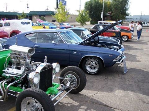 1972 Ford Ranchero - A blue 1969 muscle car with SS badging is displayed at a car show with its hood open.