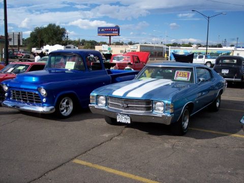 1972 Ford Ranchero - A blue 1970 Chevrolet Chevelle SS is parked at a car show next to a blue pickup truck.