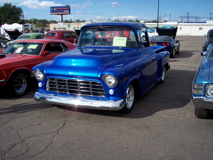 Blue 1955 pickup truck front view with chrome grille and custom hood
