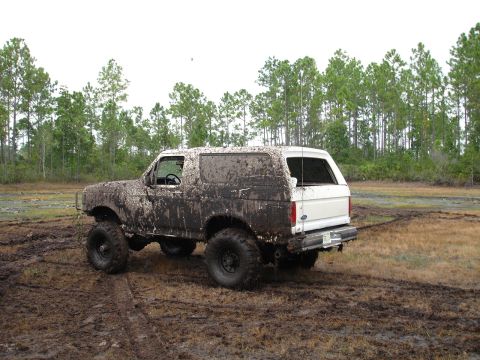 1989 Ford Bronco - This 1989 Ford Bronco is heavily covered in mud after navigating a challenging off-road course.