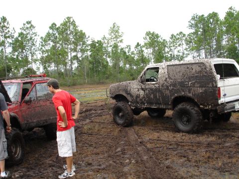 1989 Ford Bronco - Two off-road vehicles, a Ford Bronco and a Jeep Cherokee, are stuck in the mud after an outing.