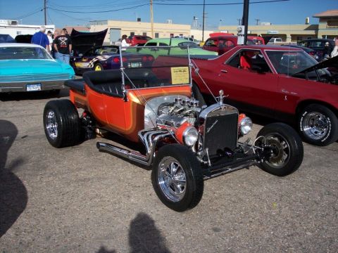 1972 Ford Ranchero - A custom hot rod with a powerful engine is displayed at a car show.