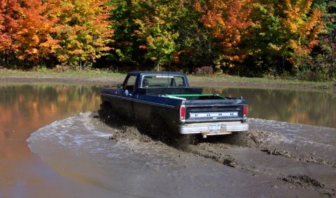1979 Ford Bronco - A Ford pickup truck navigates through a muddy trail during the fall season.
