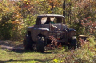 1979 Ford Bronco - This custom off-road vehicle is seen in a wooded area with autumn foliage.