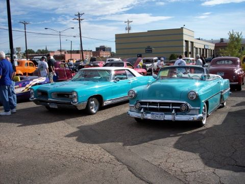 1972 Ford Ranchero - Classic cars on display at a car show, with multiple vehicles and spectators present.