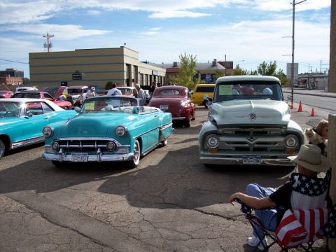 1972 Ford Ranchero - Several classic cars are on display at an outdoor event under a partly cloudy sky.