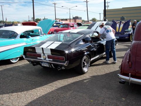 1972 Ford Ranchero - A black 1968 Ford Mustang fastback is parked at a car show with other classic vehicles.