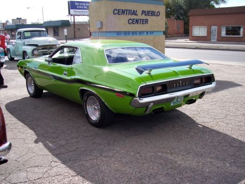 1972 Ford Ranchero - A lime green 1970 Dodge Challenger R/T is parked next to a light blue pickup truck.