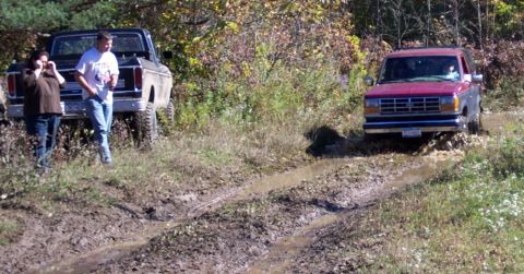 1979 Ford Bronco - A classic Ford Bronco and a Ford Ranger navigate a muddy off-road trail during autumn.
