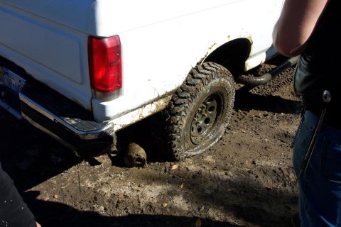 1979 Ford Bronco - Close-up of a white vehicle's rear tire and fender area.