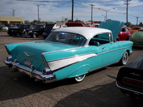 1972 Ford Ranchero - A turquoise and white 1957 Chevrolet Bel Air is parked at a car show with other vehicles.