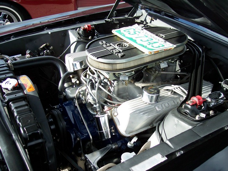 V8 engine bay with polished Cobra valve covers, oval air cleaner and white plug wires