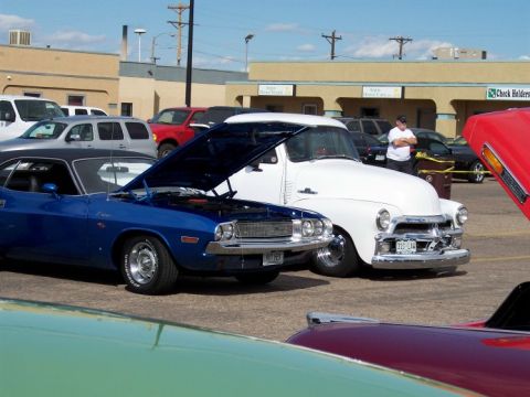 1972 Ford Ranchero - Two classic vehicles are displayed with their hoods open at an outdoor car show.