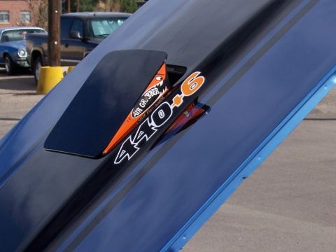 1972 Ford Ranchero - A blue car hood displays racing stripes and a scoop with "440-6" decals, with other vehicles visible in the background.