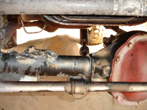 1989 Ford Bronco - Close-up view of the undercarriage, focusing on the differential and driveshaft components.