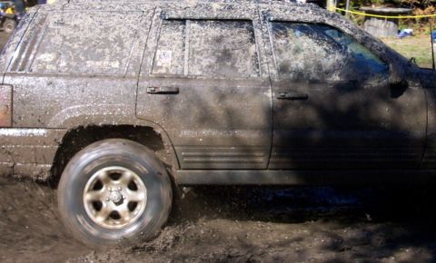 1979 Ford Bronco - SUV covered in mud navigating a muddy terrain.