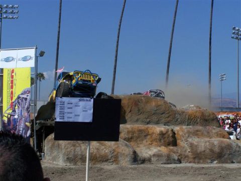1995 Ford Bronco - An off-road buggy navigates a challenging course, with spectators watching from the side.