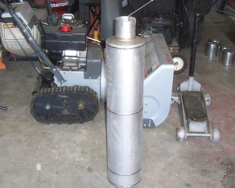 1994 Ford F-150 - An exhaust muffler is shown with a snowblower and a hydraulic jack in the background.