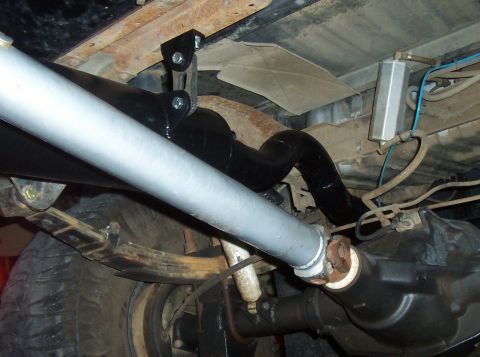 1994 Ford F-150 - The underside of a truck reveals its exhaust system, driveshaft, and rear axle components, suggesting a model year around 1990.