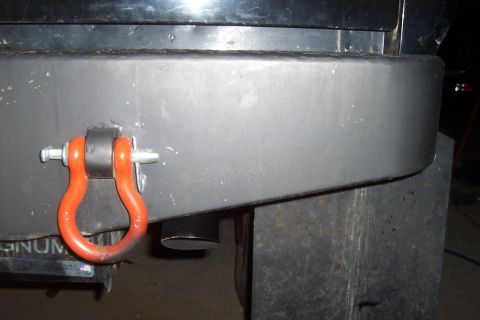 1994 Ford F-150 - Close-up of a red recovery shackle mounted on a vehicle's rear bumper.