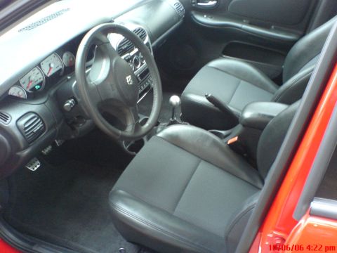 2005 Dodge SRT-4 - The interior of a 2005 Dodge SRT-4 features a sporty steering wheel, clear gauges, and black cloth and leather seats.