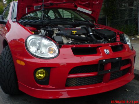 2005 Dodge SRT-4 - Front view of a red 2005 Dodge SRT-4 with the hood open, revealing the engine.
