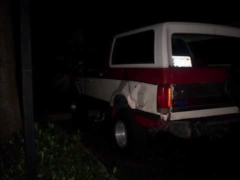 1989 Ford Bronco - This damaged Ford Bronco shows extensive crumpling on its rear passenger side panel and bumper.
