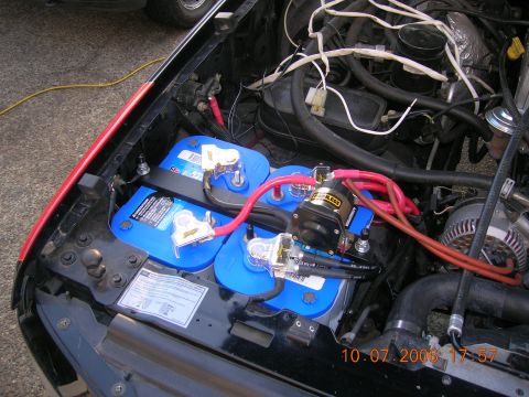 1996 Ford Bronco - Dual Optima batteries are installed in the engine bay, connected by red cables and a solenoid. The date stamp reads 10.07.2006.