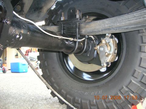 1996 Ford Bronco - Close-up view of the rear axle assembly and suspension components of a vehicle.