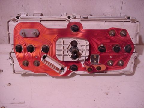 1979 Ford Bronco - The back of a vehicle's instrument cluster shows its complex circuit board and wiring.