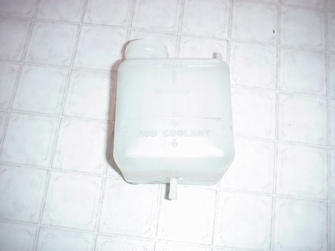 1979 Ford Bronco - Plastic coolant reservoir with markings for minimum and maximum fill levels.