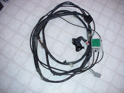 1979 Ford Bronco - A complex wiring harness with a green module is shown, disconnected from a vehicle.